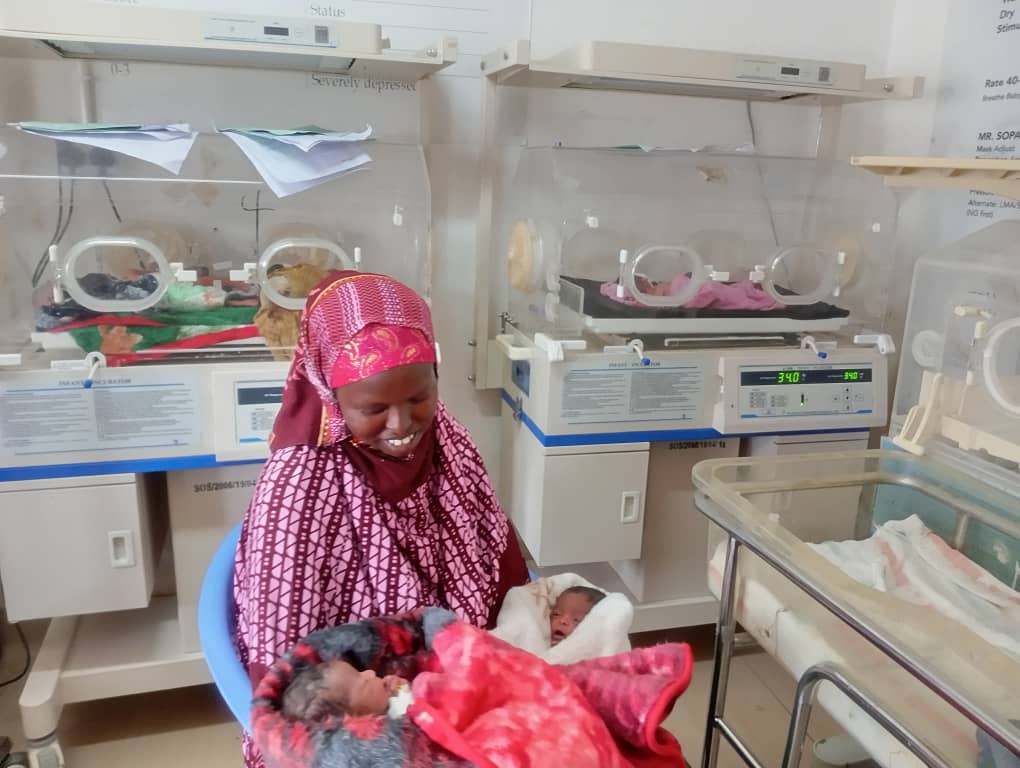 Abshiro can’t stop smiling as she cuddles her newborn twins — a heartwarming moment full of love and hope in the neonatal unit. 